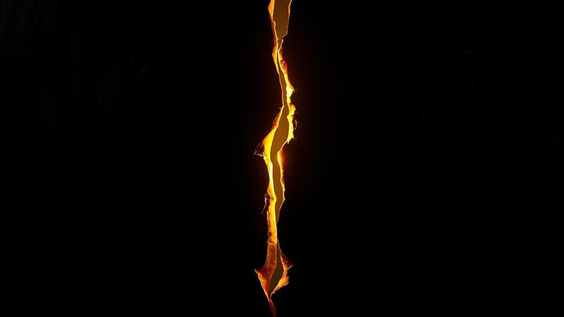 A jagged golden crack splitting a dark wall, light bleeding through